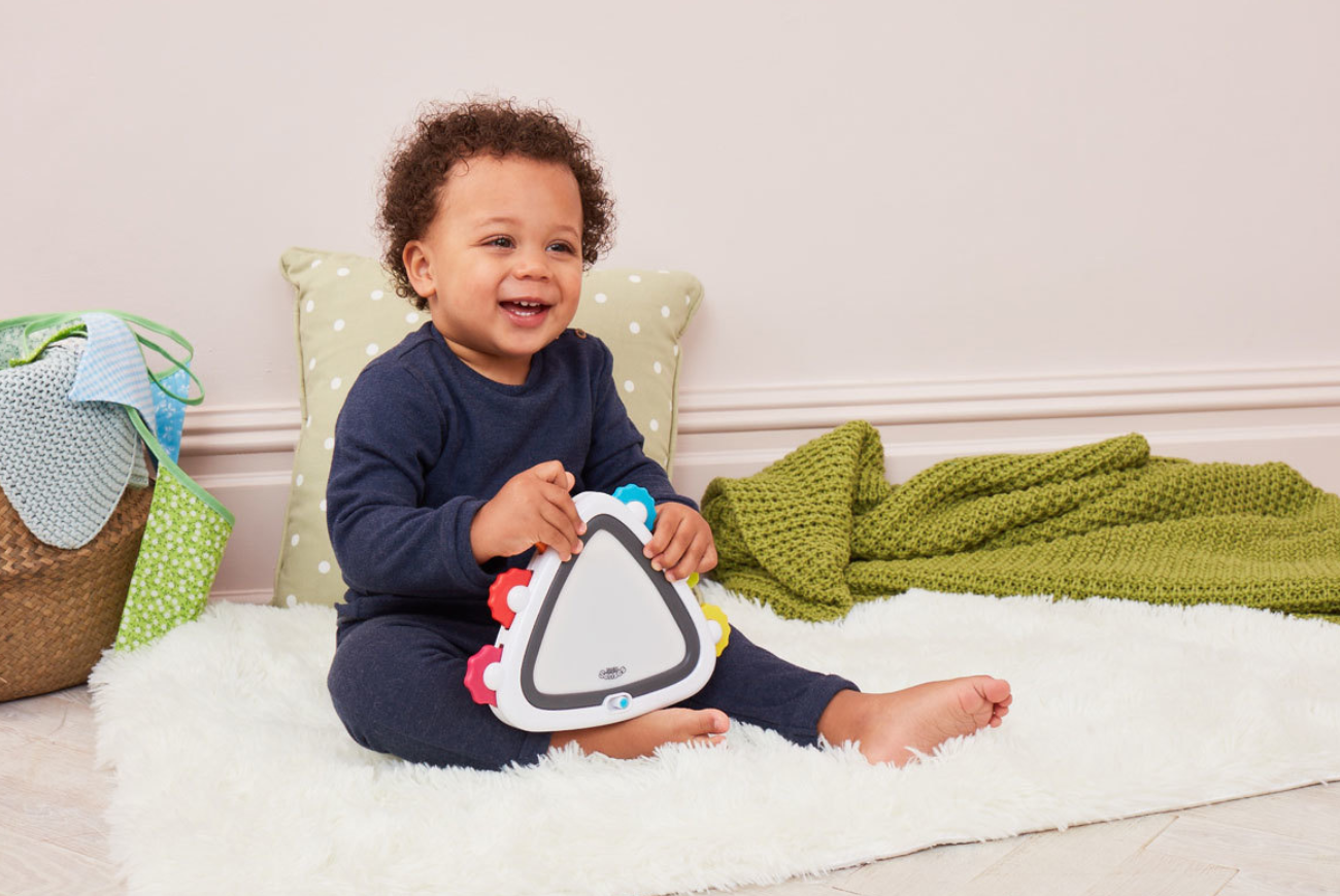 Young boy playing with a musical toy from Early Learning Centre