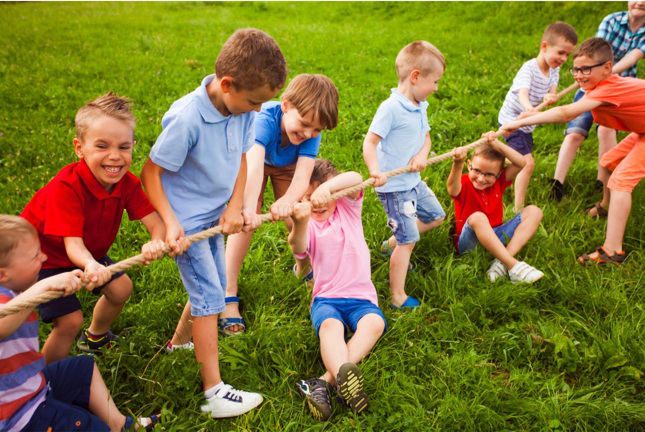 Children play tug of war.