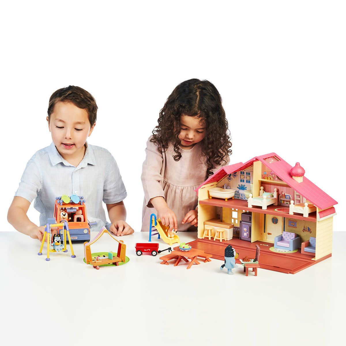 Two children play with Bluey figures.