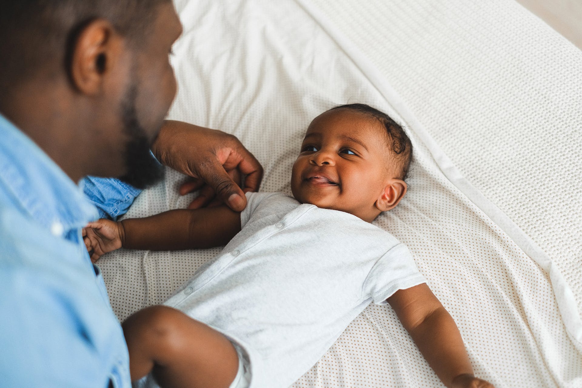 Baby and dad playing.