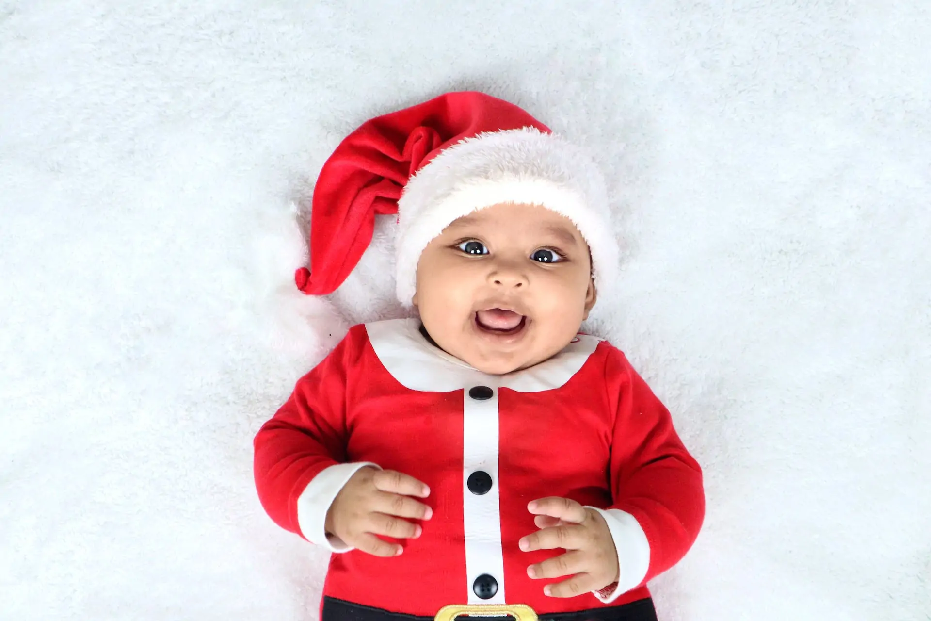 Baby in christmas outfit.