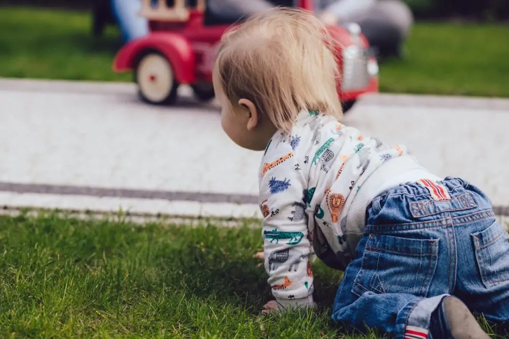 Child crawling outside.