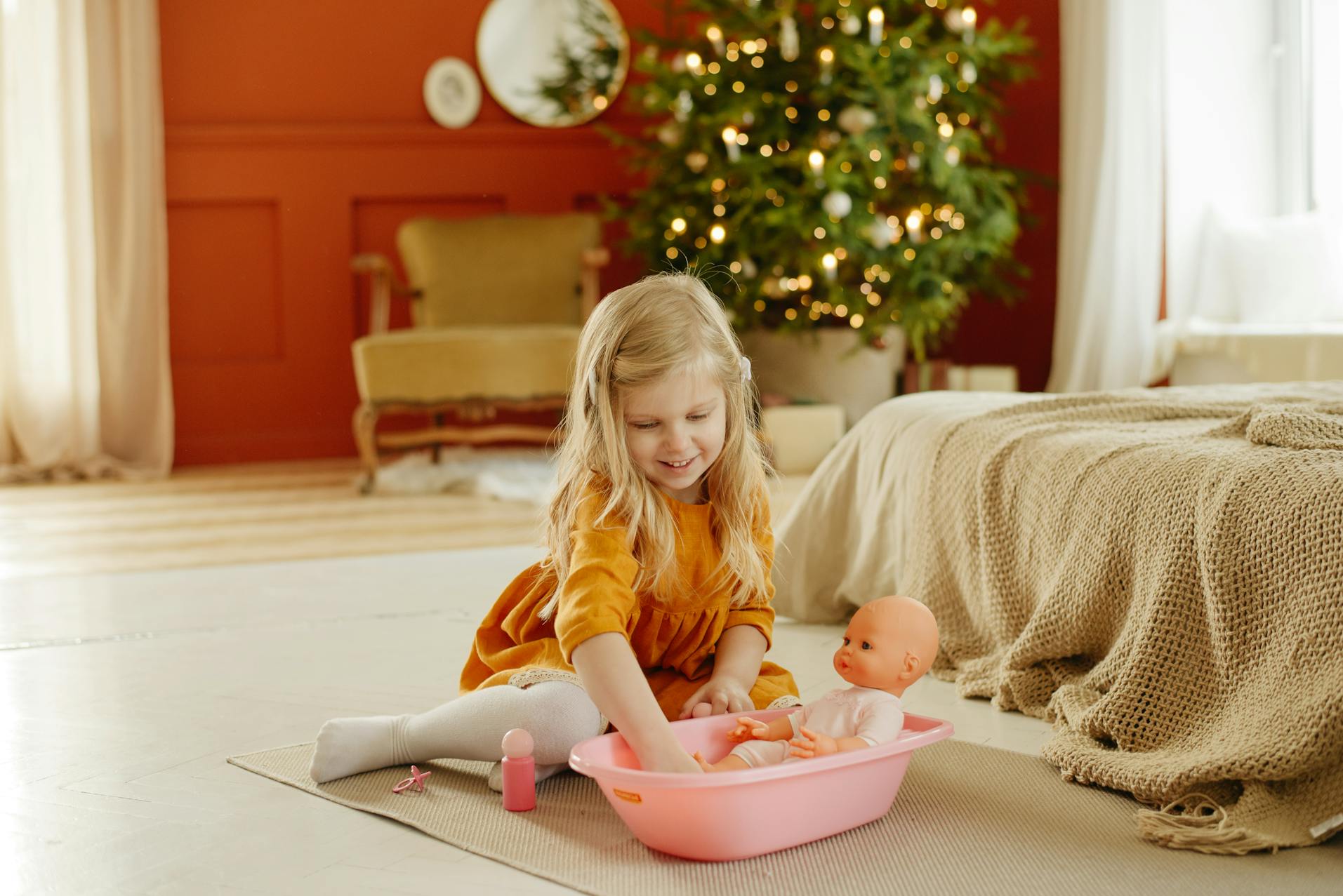 Girl plays with doll.