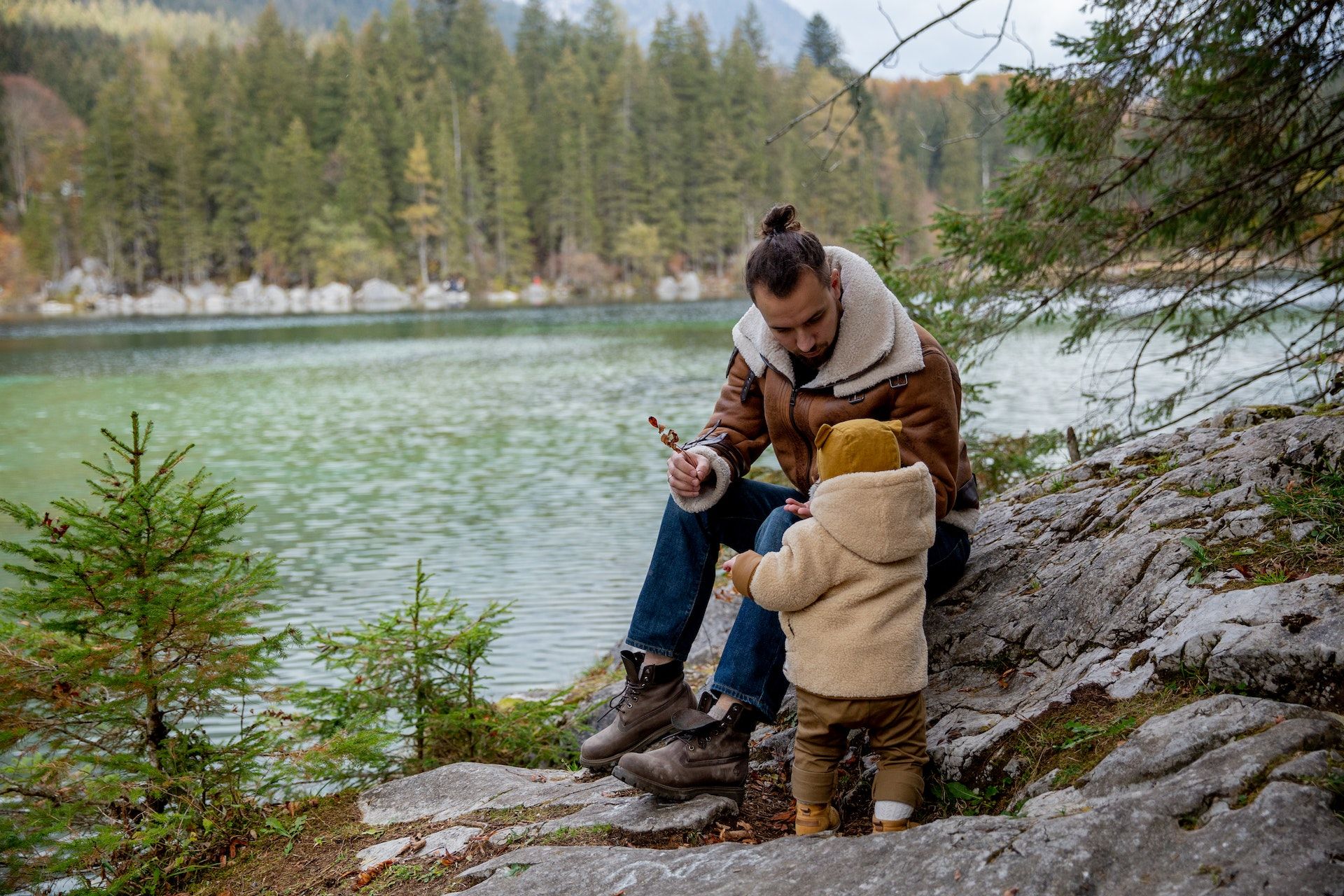 Dad and baby by lake.