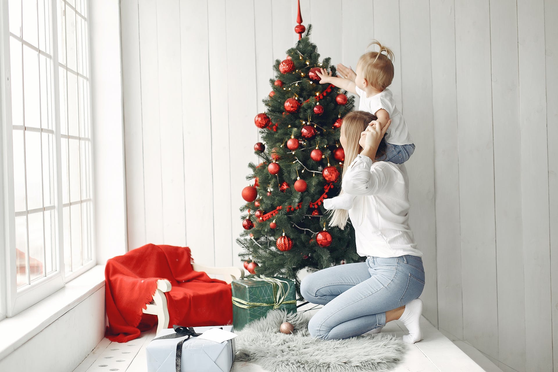 Mum and daughter decorating christmas tree.