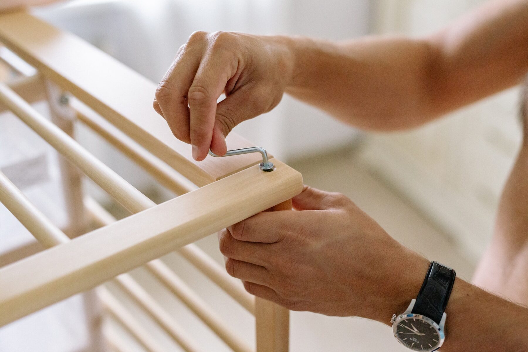 Parent fixing baby's cot.