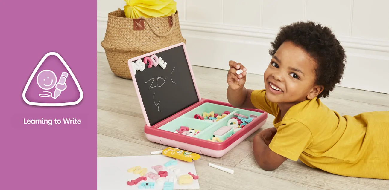 Boy writing on chalk board