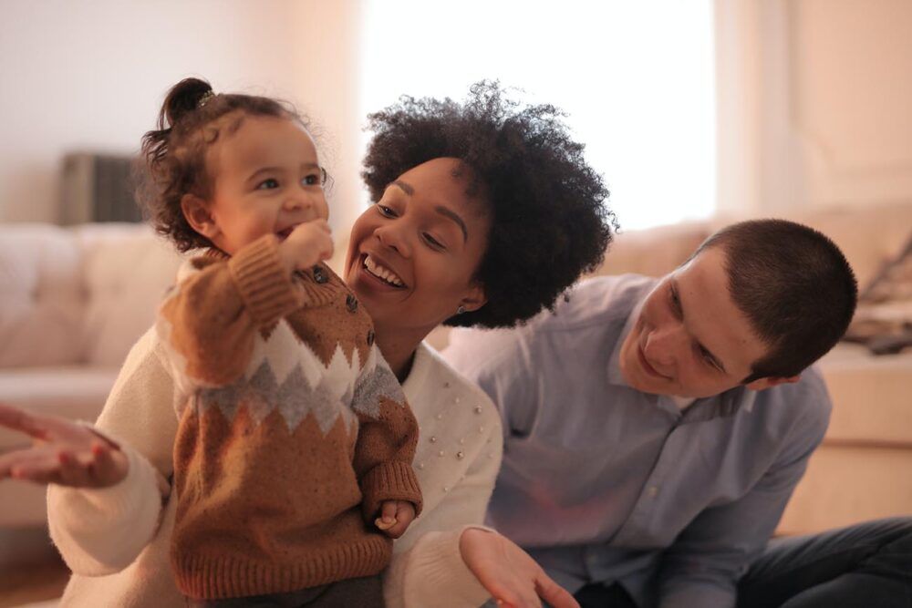 parents looking at their toddler and smiling