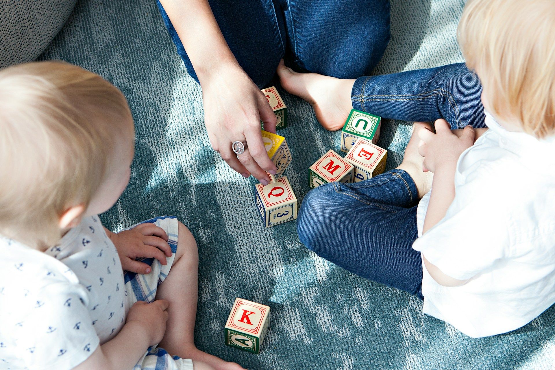 Kids playing with letter blocks.