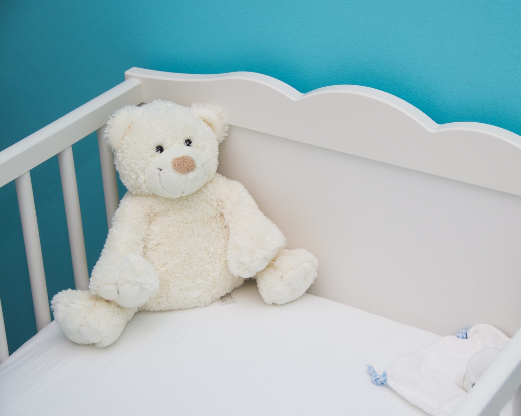 Teddy on baby's cot.