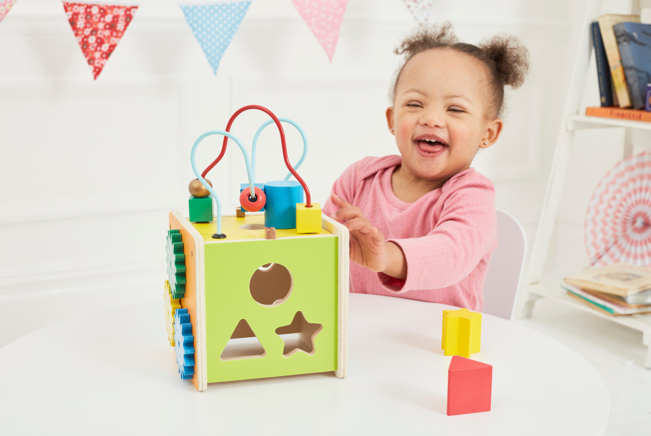 Girl playing with puzzle activity toy