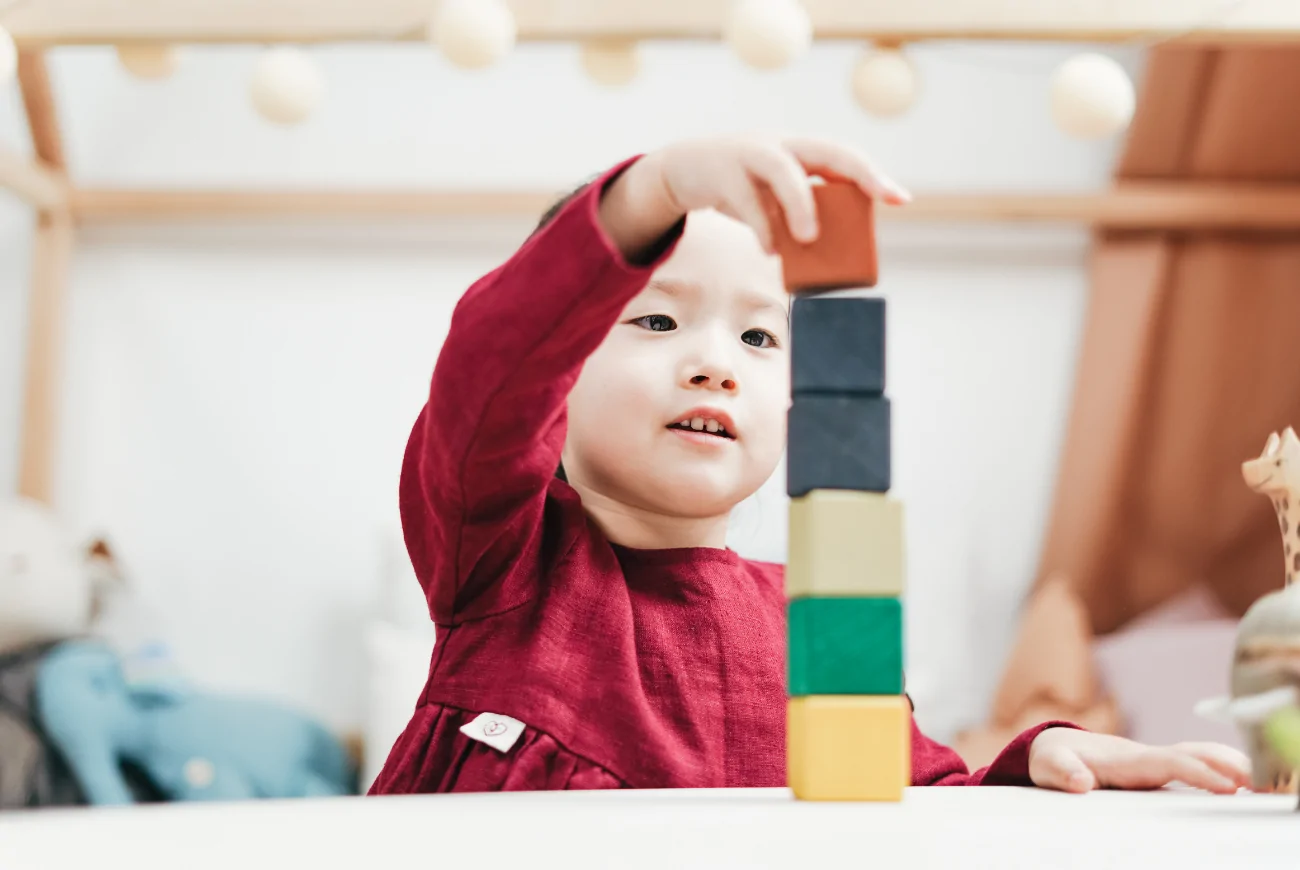 Child stacking building blocks.