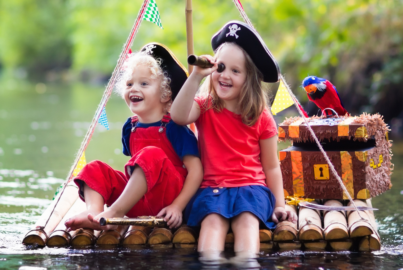 Two girls playing pirates on a raft